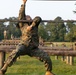 Marines with Marine Corps Combat Service Support Schools maneuver through an obstacle course