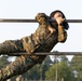 Marines with Marine Corps Combat Service Support Schools maneuver through an obstacle course