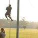 Marines with Marine Corps Combat Service Support Schools maneuver through an obstacle course