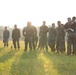 Marines with Marine Corps Combat Service Support Schools maneuver through an obstacle course