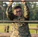 Marines with Marine Corps Combat Service Support Schools maneuver through an obstacle course