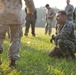 Marines with Marine Corps Combat Service Support Schools maneuver through an obstacle course