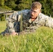 Marines with Marine Corps Combat Service Support Schools maneuver through an obstacle course