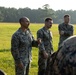 Marines with Marine Corps Combat Service Support Schools maneuver through an obstacle course