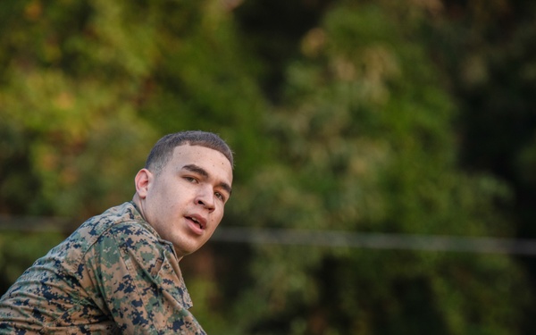 Marines with Marine Corps Combat Service Support Schools maneuver through an obstacle course