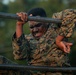 Marines with Marine Corps Combat Service Support Schools maneuver through an obstacle course