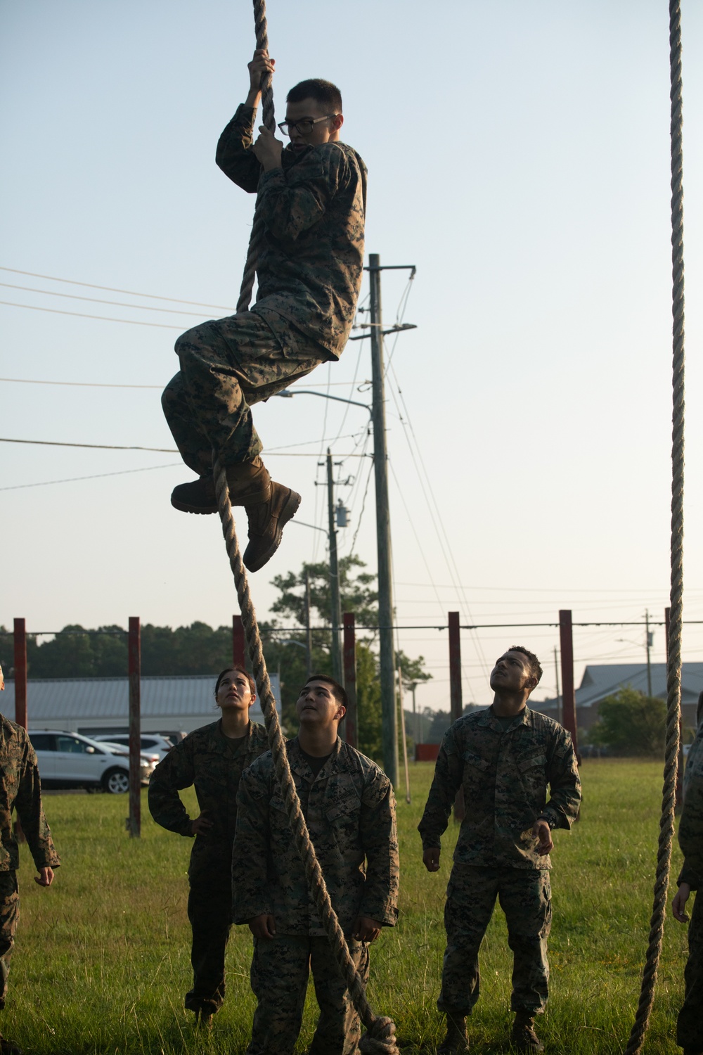 Marines with Marine Corps Combat Service Support Schools maneuver through an obstacle course