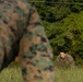 Marines with Marine Corps Combat Service Support Schools maneuver through an obstacle course