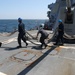 Sailors aboard the USS Howard conduct a sea and anchor detail in Yokosuka, Japan