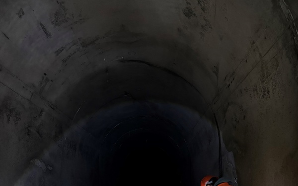 Swiss engineer investigates a worn area in the Solis sediment bypass tunnel