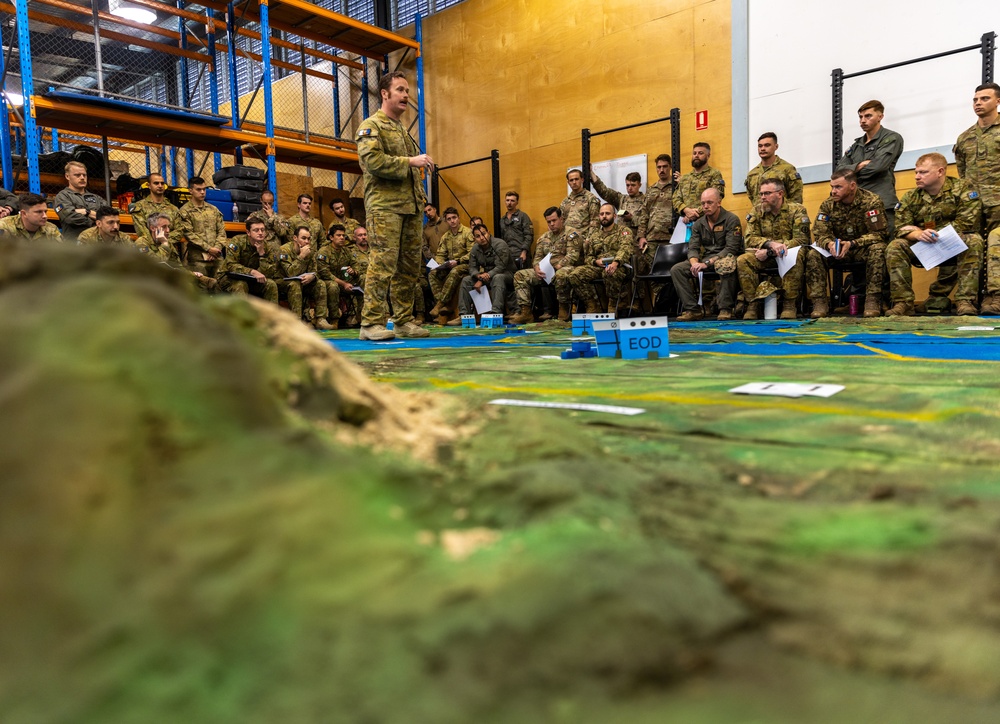 Multinational service members conduct a rehearsal of concept drill during Operation Render Safe 24