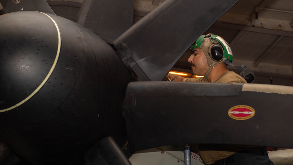 Aviation Machinist’s Mate Maintains a C-2A Greyhound Aboard Theodore Roosevelt