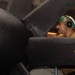 Aviation Machinist’s Mate Maintains a C-2A Greyhound Aboard Theodore Roosevelt