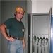 Army Sustainment Command G4 (Logistics) engineer William Ellis examines a weapons storage locker.