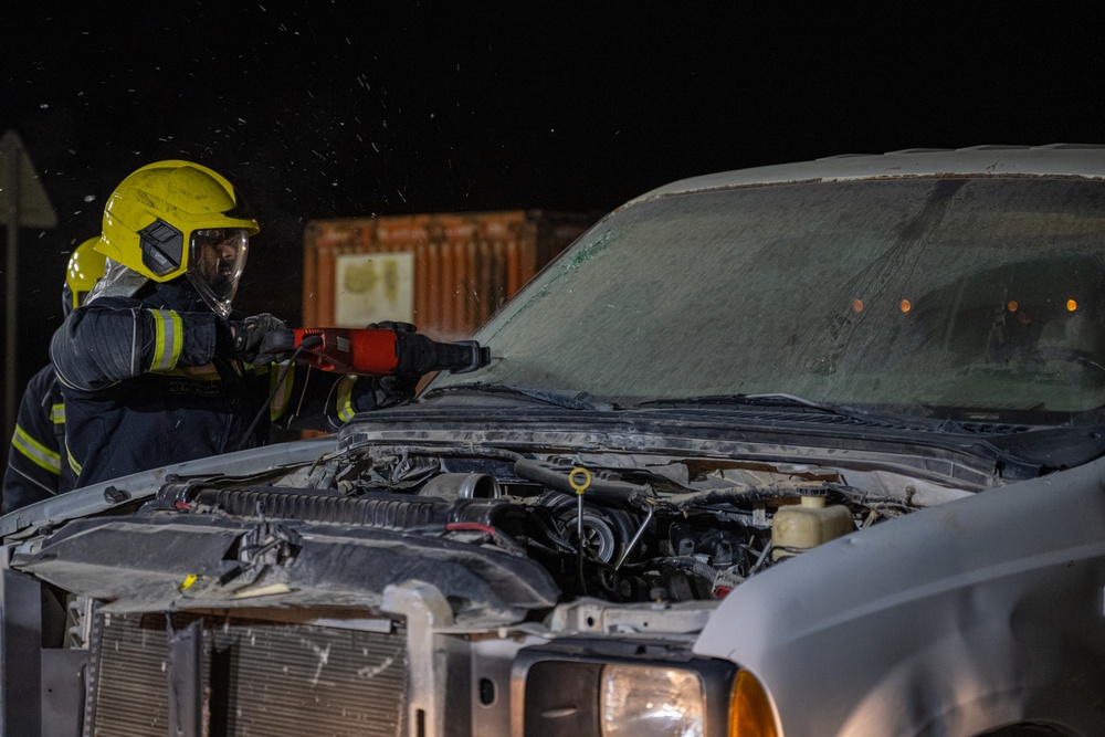 379th ECES firefighters practice vehicle extrication with host nation partners