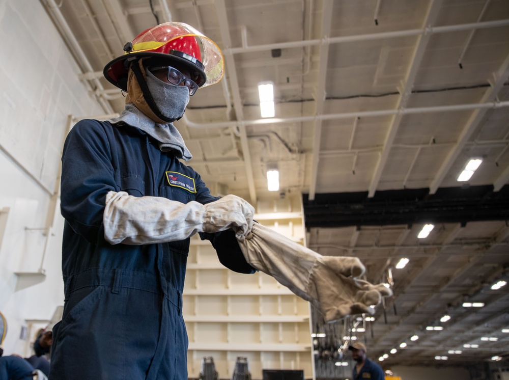 USS George Washington (CVN 73) Sailors practice pipe patching during damage control training