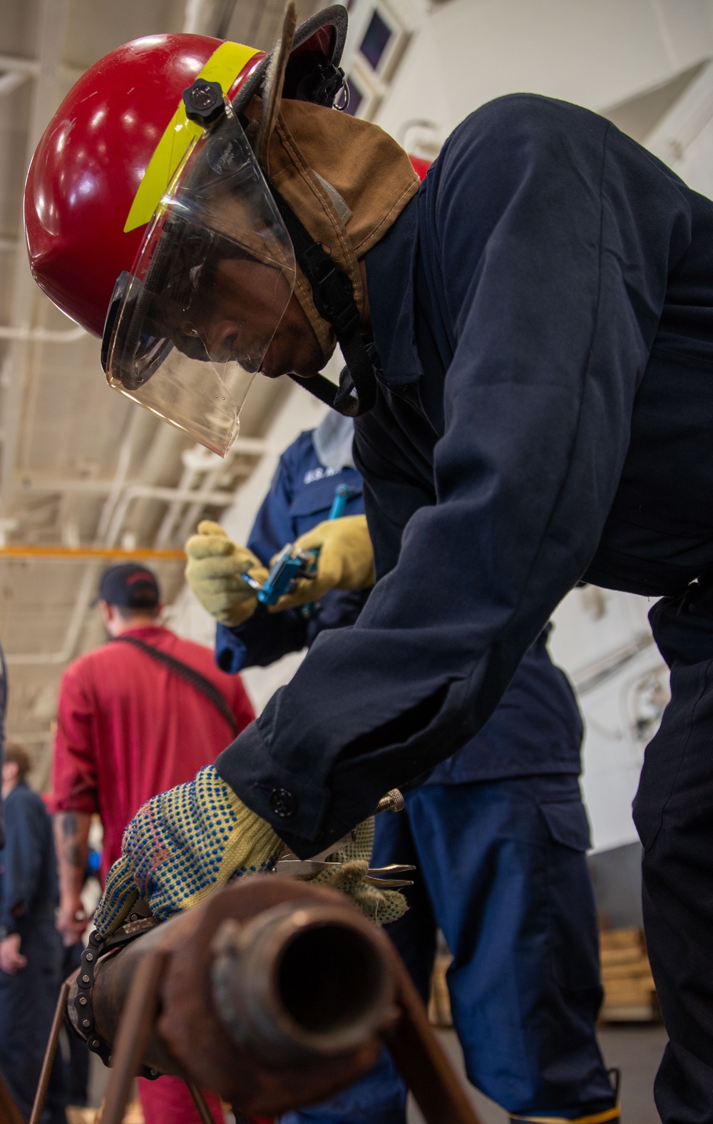USS George Washington (CVN 73) Sailors practice pipe patching during damage control training