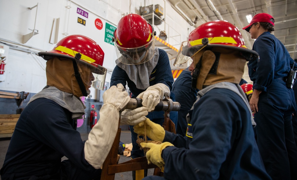 USS George Washington (CVN 73) Sailors practice pipe patching during damage control training