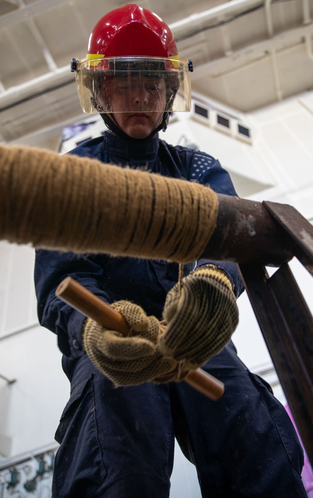 USS George Washington (CVN 73) Sailors practice pipe patching during damage control training