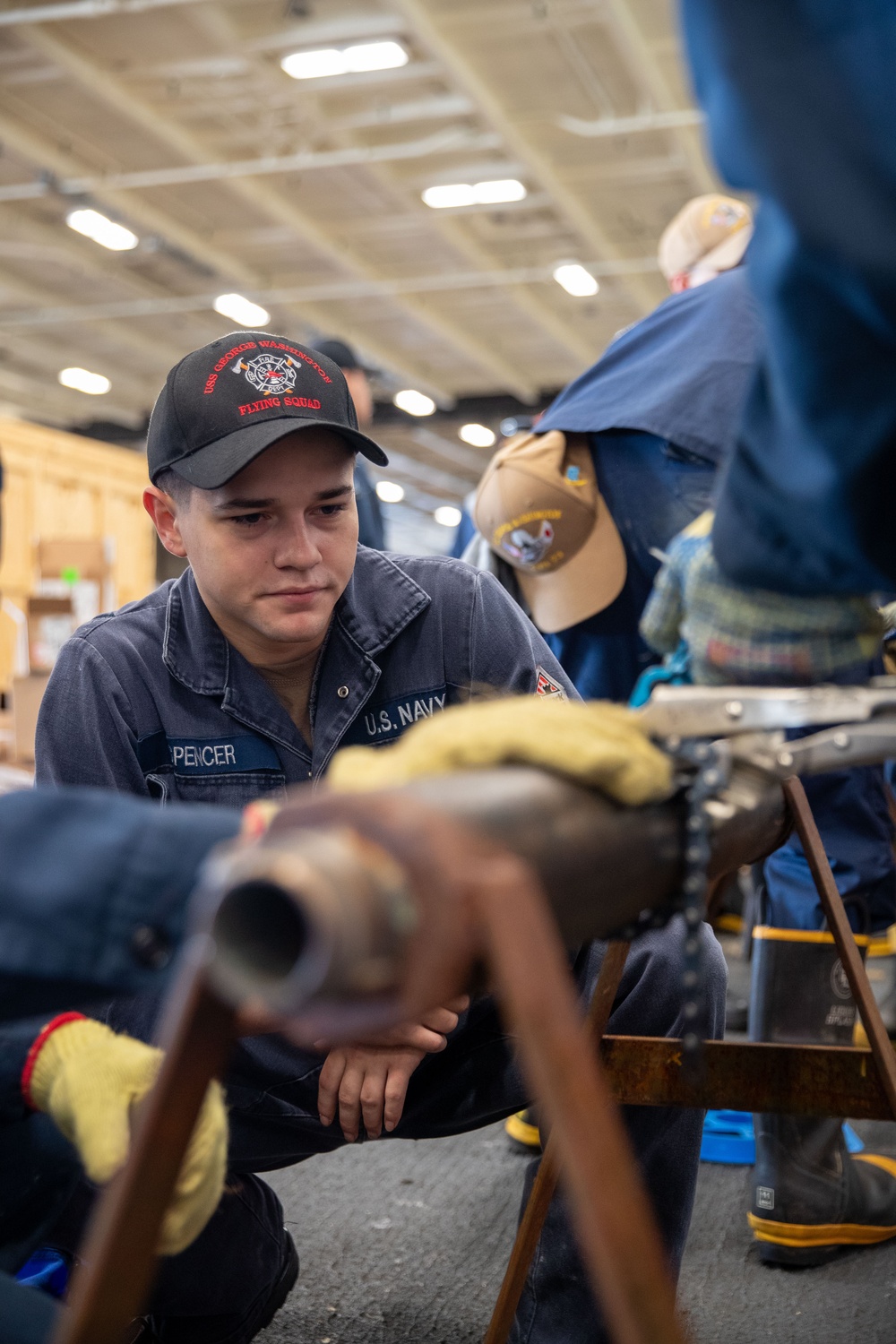 USS George Washington (CVN 73) Sailors practice pipe patching during damage control training