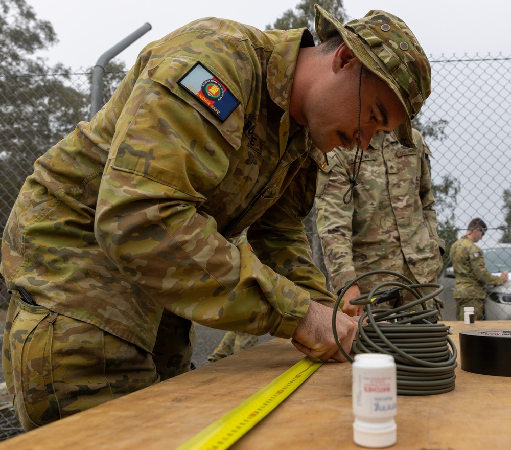 Team of joint multinational service members conducts simulated live explosive disposal training during Operation Render Safe 24