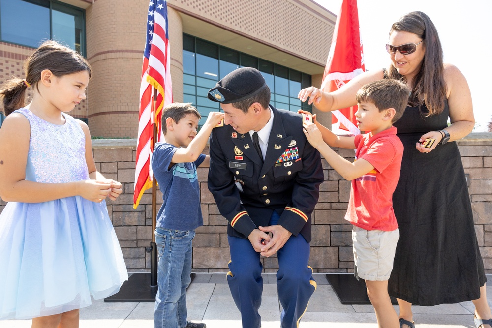 LTC. Donald K. Lew's family pins on his new rank.