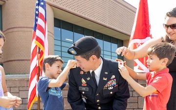 LTC. Donald K. Lew's family pins on his new rank.