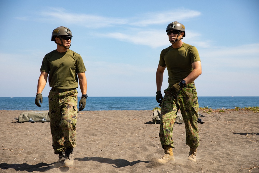 Members of the Japanese armed forces walk to prepare their boats during Super Garuda Shield 2024