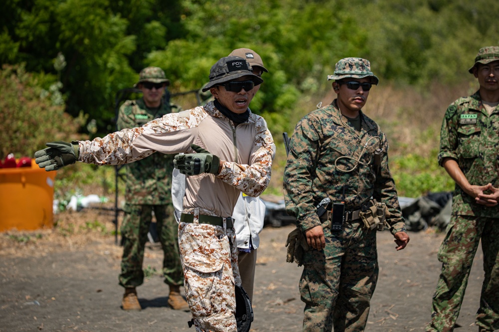 Nanda Wijaya (left), a civilian interpreter, translates instructions to members of the Indonesian National Armed Forces Korps Marinir during Super Garuda Shield 2024