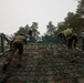 Swedish service members lead U.S. Marines through obstacle course