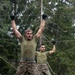 Swedish service members lead U.S. Marines through obstacle course