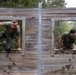 Swedish service members lead U.S. Marines through obstacle course