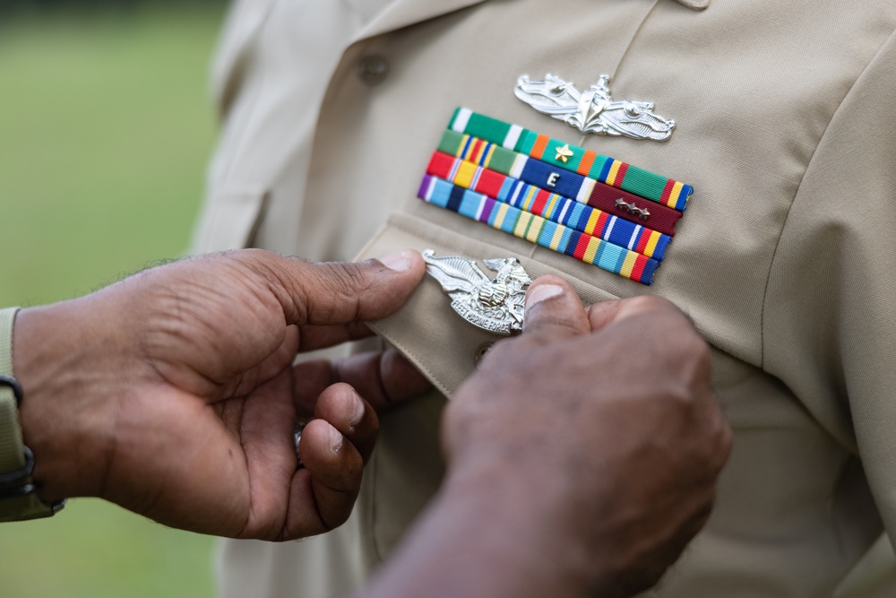 U.S. Navy Chief Religious Program Specialist Kenneth Armstead receives the Fleet Marine Force Warfare Insignia