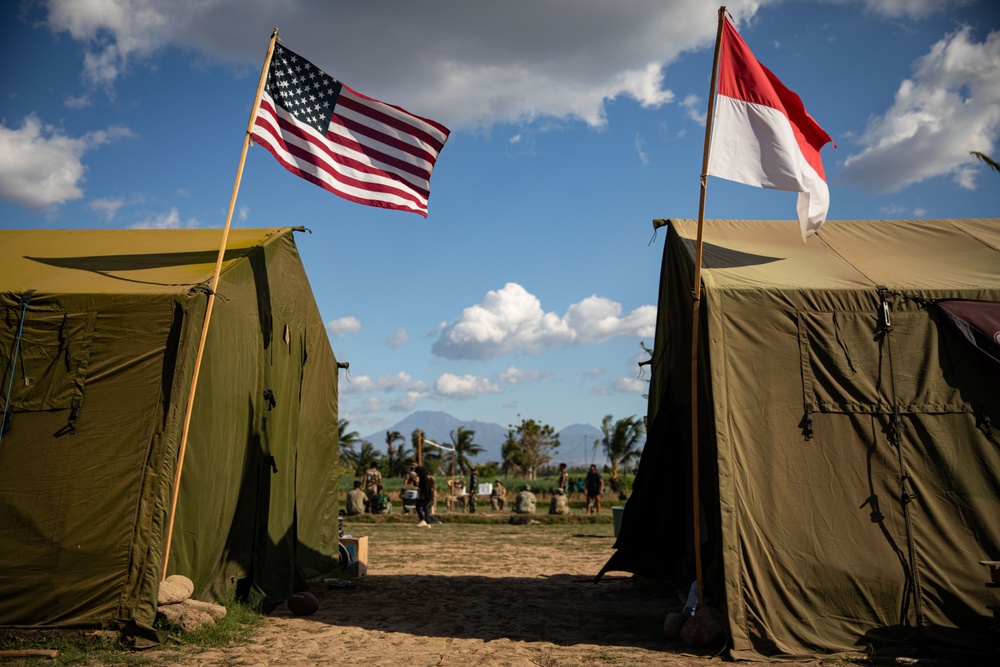 The flags of the United States of America and the Republic of Indonesia fly above Sekolah Dasar Negeri 2, during Super Garuda Shield 2024