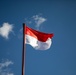 The flag of the Republic of Indonesia flies above Sekolah Dasar Negeri 2, during Super Garuda Shield 2024
