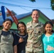 U.S. Army Sgt. 1st Class Kelly Carter of the 610th Engineer Support Company, 864th Engineer Battalion, takes a picture with local children during Super Garuda Shield 2024