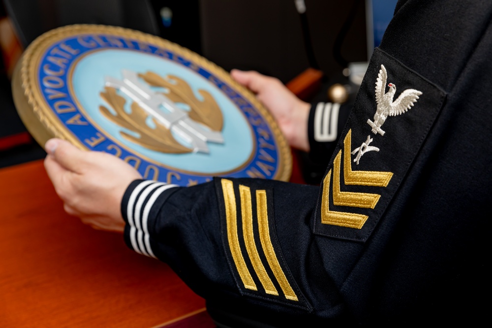 Legalman Holds a Judge Advocate General’s Corps Insignia
