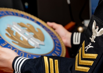 Legalman Holds a Judge Advocate General’s Corps Insignia