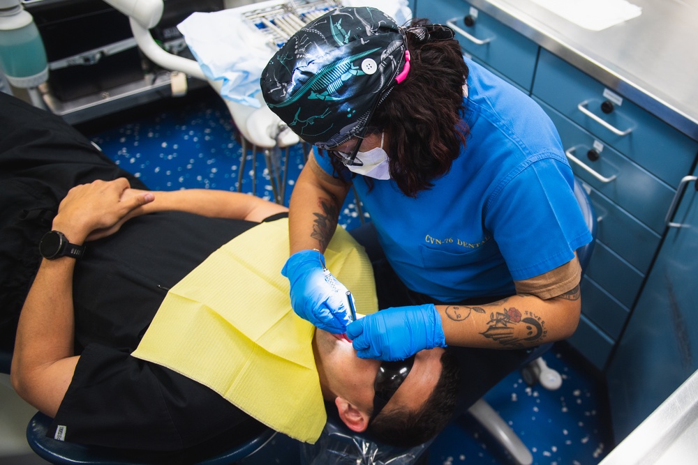 USS Ronald Reagan (CVN 76) Sailors conduct dental procedure