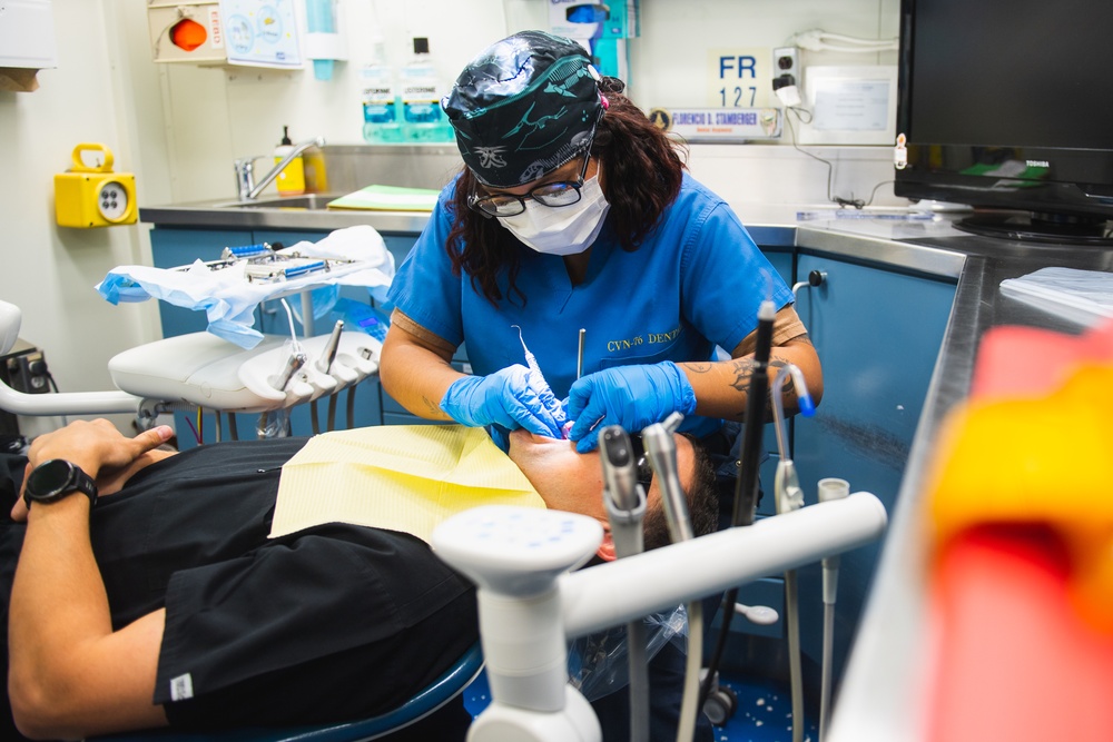 USS Ronald Reagan (CVN 76) Sailors conduct dental procedure