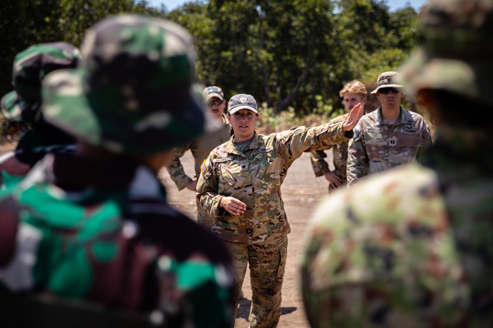 U.S. Army Spc. Biranna Ramirez briefs Members of the Indonesian National Armed Forces and Japanese Self Defence Force on the sling load training exercise during Super Garuda Shield 2024