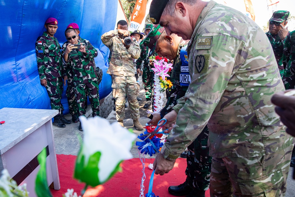 New Zealand Army Col. Paul Hayward, deputy commander of interoperability of the 25th Infantry Division, cuts the ribbon at the newly refurbished school in Palangan, Indonesia during Super Garuda Shield