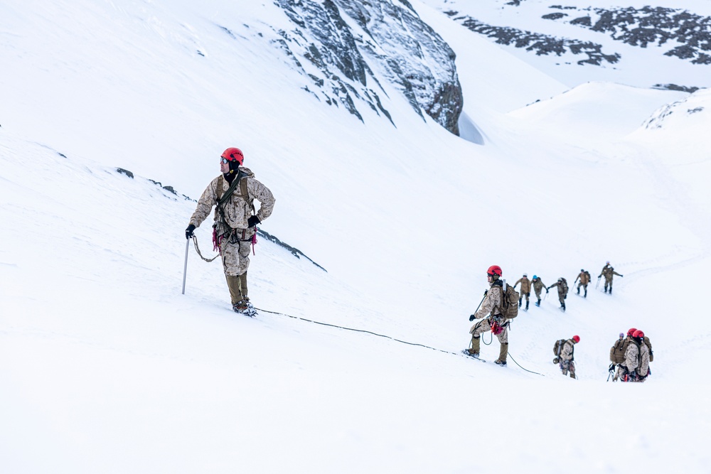 U.S. Marine Corps Mountain Warfare Instructors climbs toward mountain summit with Argentine marines