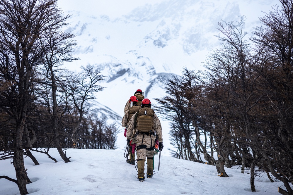 U.S. Marine Corps Mountain Warfare Instructors climbs toward mountain summit with Argentine marines