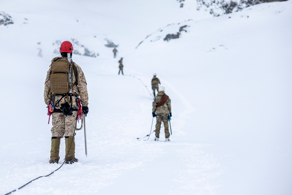 U.S. Marine Corps Mountain Warfare Instructors climbs toward mountain summit with Argentine marines