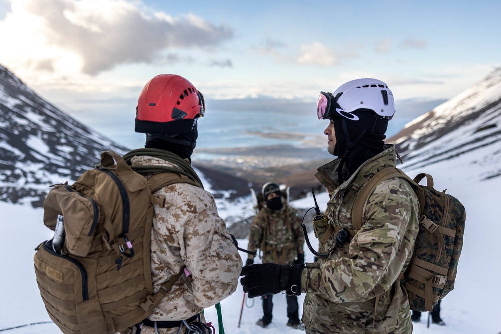 U.S. Marine Corps Mountain Warfare Instructors climbs toward mountain summit with Argentine marines