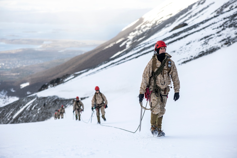 U.S. Marine Corps Mountain Warfare Instructors climbs toward mountain summit with Argentine marines