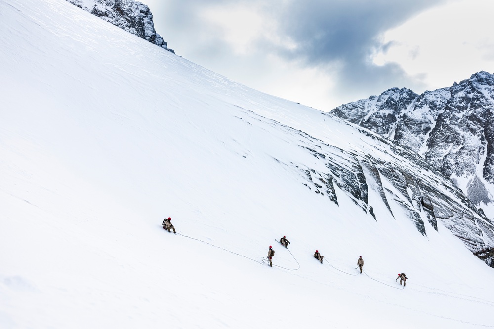 U.S. Marine Corps Mountain Warfare Instructors climbs toward mountain summit with Argentine marines