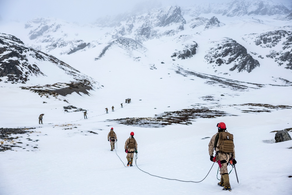 U.S. Marine Corps Mountain Warfare Instructors climbs toward mountain summit with Argentine marines