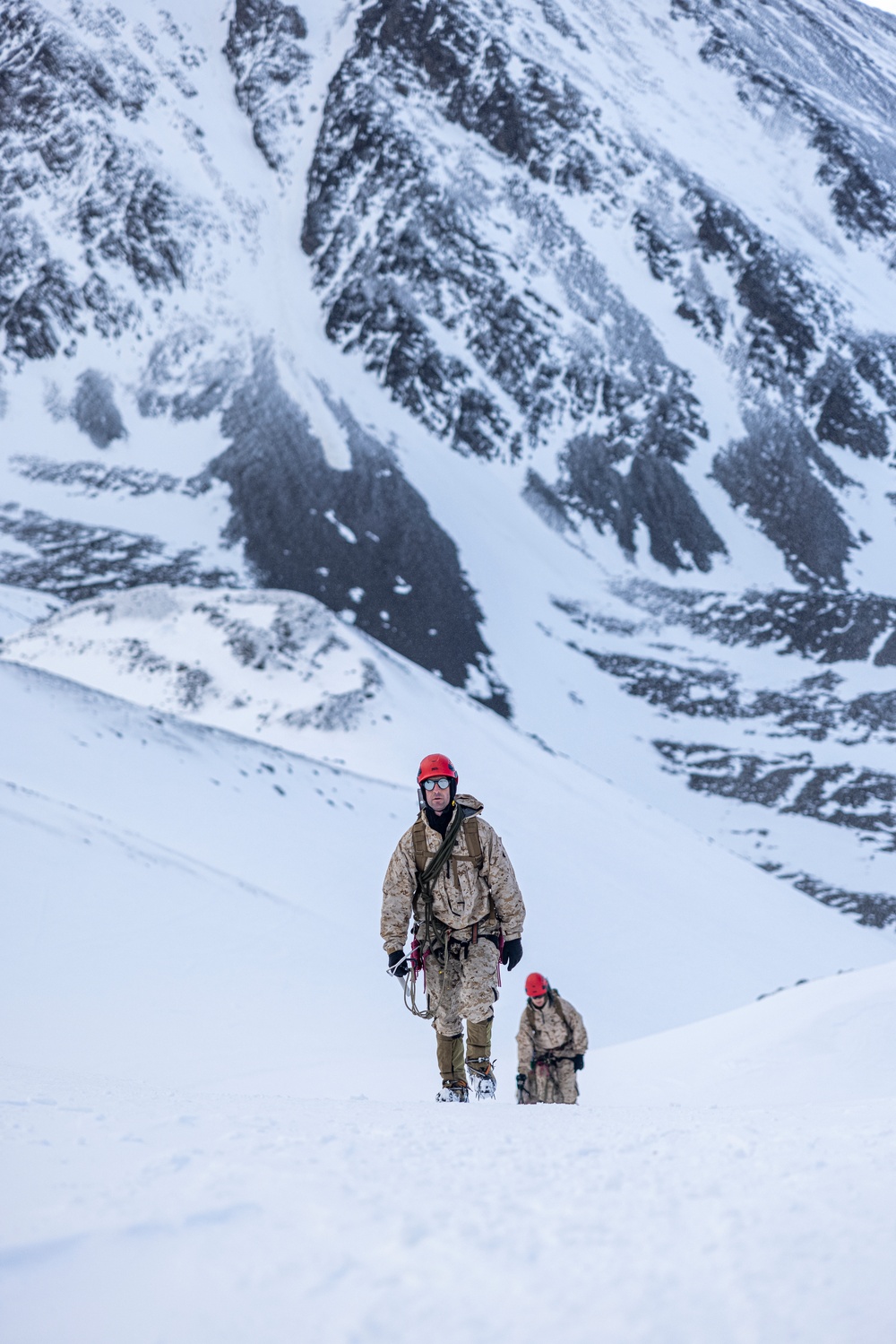 U.S. Marine Corps Mountain Warfare Instructors climbs toward mountain summit with Argentine marines